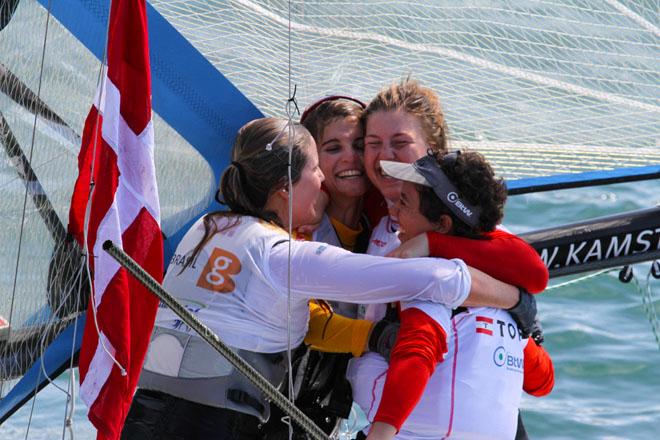 Gold and silver 49erFX embrace. &copy; ISAF 